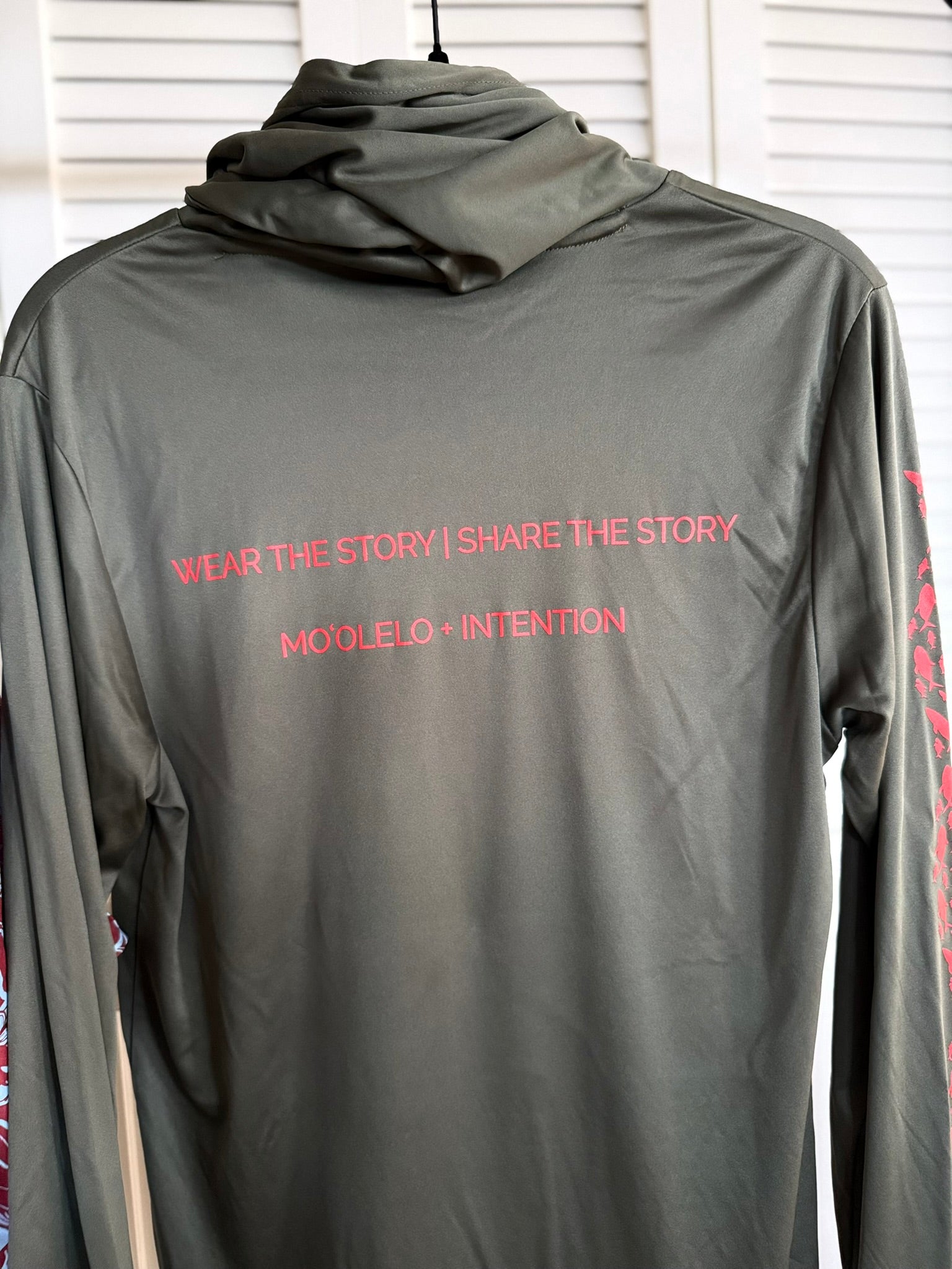 Olive hoodie with red words "Wear the Story Share the Story."
