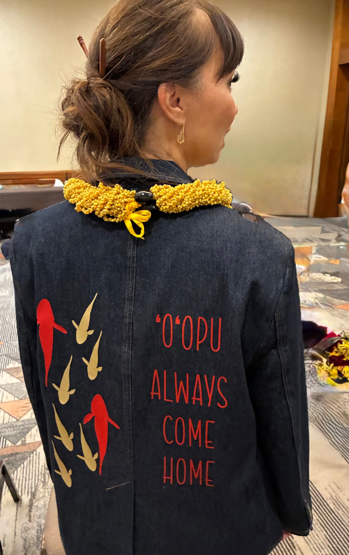 Back of The Returning Blazer with gold and red 'o'opu and the words 'O'opu Always Come Home